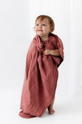 Baby wrapped in Baby Blanket in Ember on a white background
