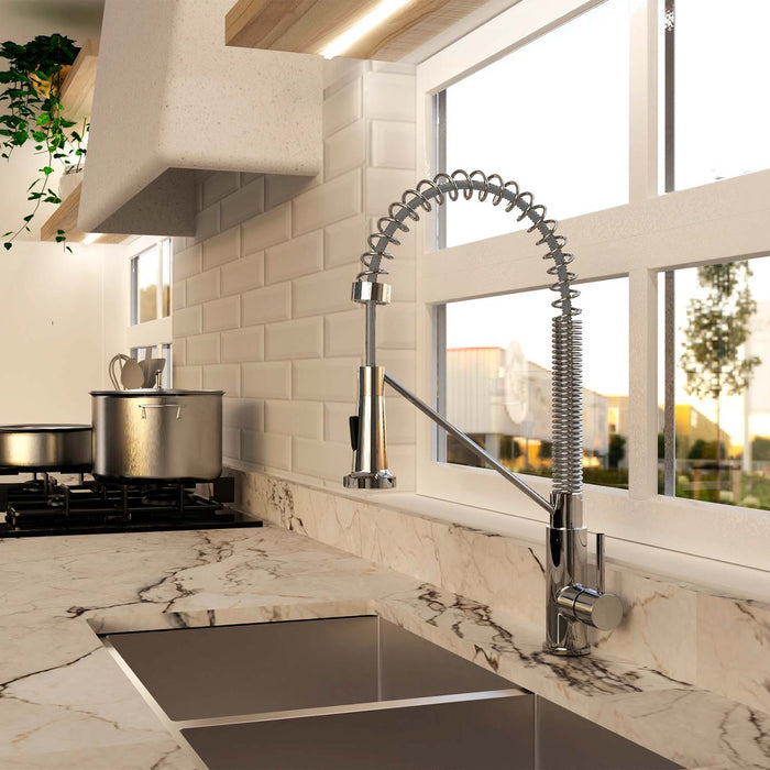 Modern kitchen with marble countertop, sink, and stainless steel faucet.