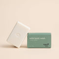Two bars of solid body wash, one white and one green, with 'Kyte Skin' branding on a beige background.