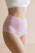 Light pink underwear worn by a person on a beige background